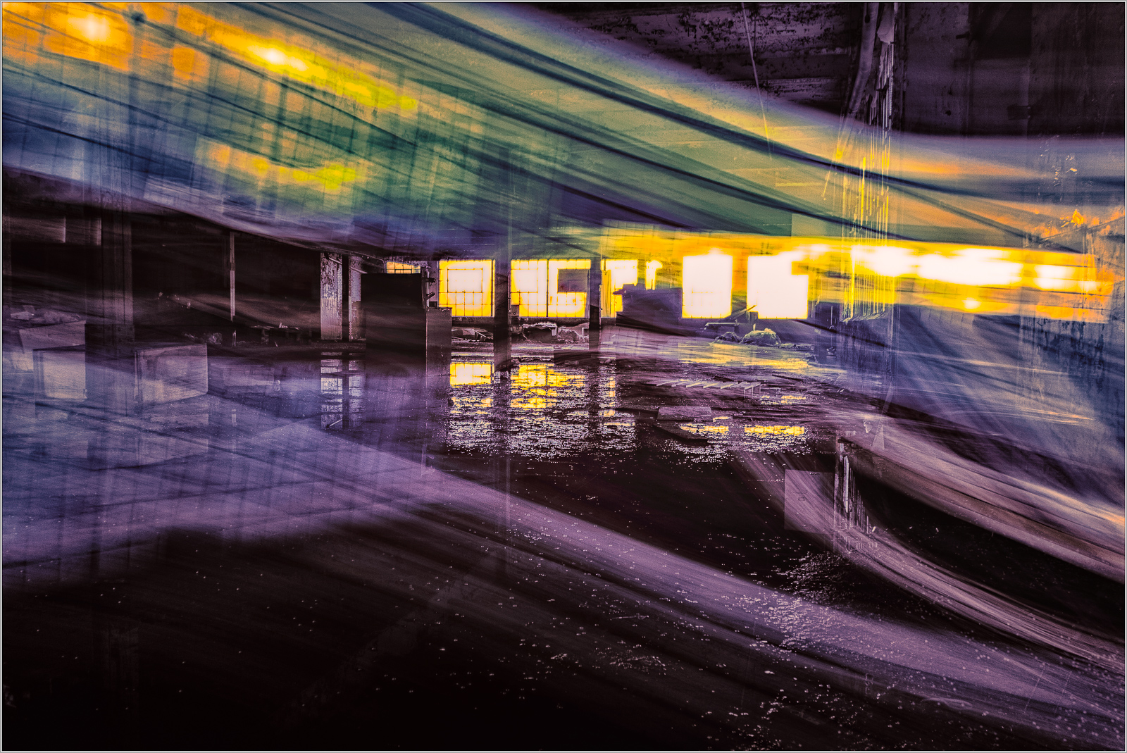A vibrant display of light and color in an abandoned industrial space.