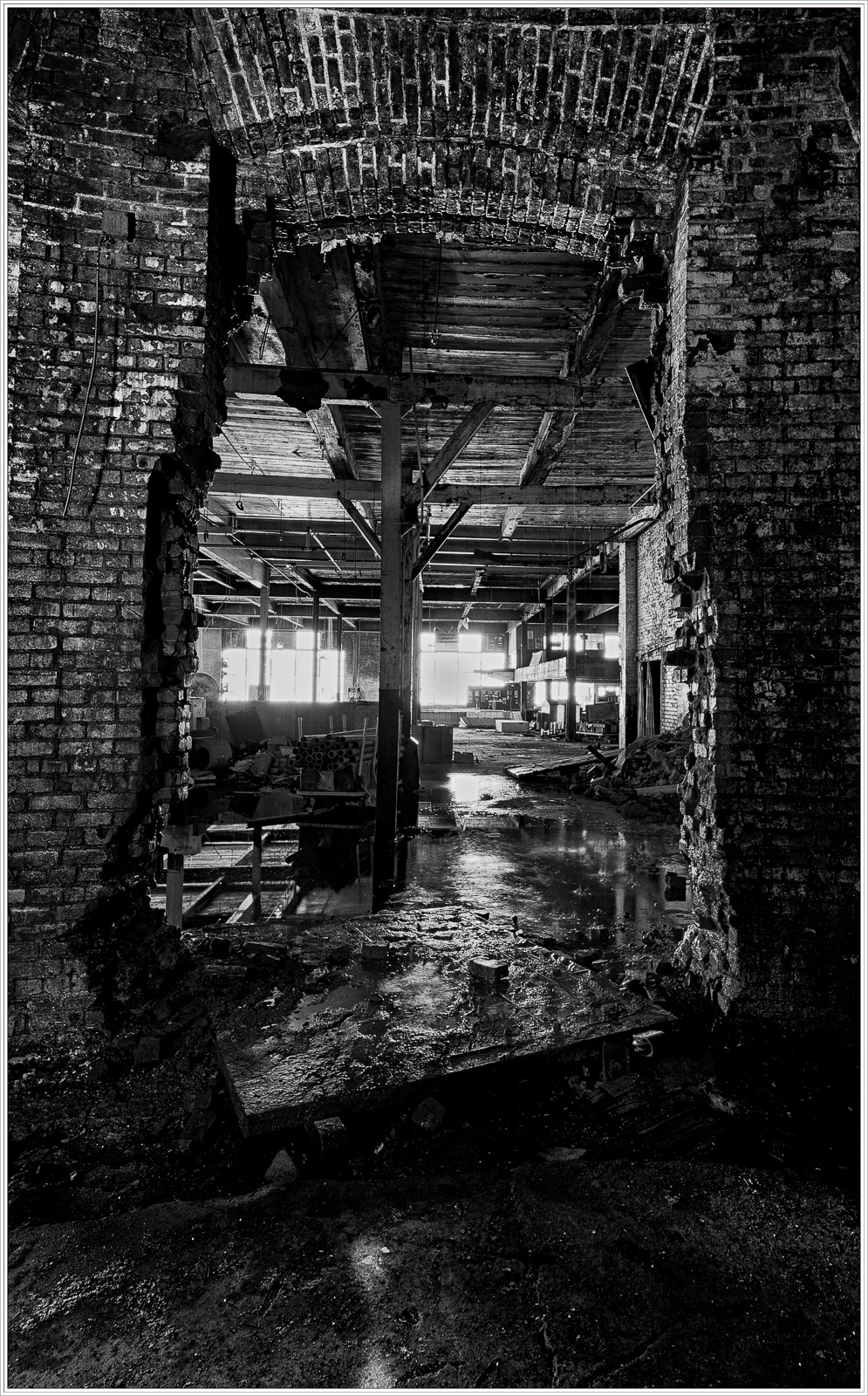 A broken wall reveals a dimly lit, abandoned interior with brick and wood textures.