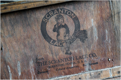 Vintage wooden crate with Scranton Lace Co. logo and cartoon character design.