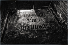 Historic Scranton Lace Factory floor with faded text, revealing industrial past.