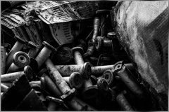 A tangle of discarded metallic components, weathered and rusted, reveals the passage of time.