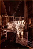 An old, worn wooden desk draped with a faded lace cloth, hinting at forgotten stories.
