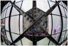 Abandoned building window with rusted metal and peeling glass