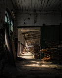 Interior corridor of Scranton Lace Building, featuring wood stacks and natural light