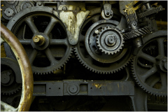 Intricate gears and machinery intertwine, showcasing industrial engineering.