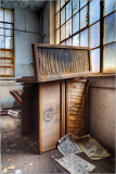 Dusty relics stacked, sunlight trickles through grimy panes, history whispers.