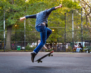 A person performs a skateboard trick mid-air, defying gravity and common sense.