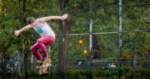 A skater defies gravity mid-air in a park, channeling inner space-time curiosity.