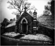 A hauntingly beautiful mausoleum draped in ghostly snow.