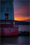 Tarrytown Lighthouse at sunset, highlighting structural details and color gradients.