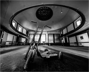 A lonely tricycle gazes longingly at the empty room, pondering existential questions.