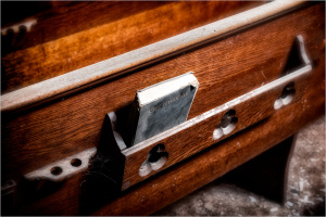 A forgotten book tucked in an old wooden shelf, whispering secrets of the past.