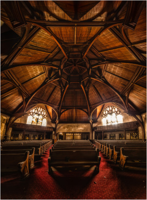 Interior of a historic church featuring intricate wooden architecture and pews