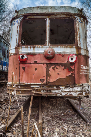 Rusty trolley car in a forgotten graveyard, emblem of transit history
