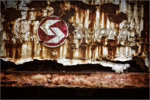Faded signage clings to rusted metal, echoing forgotten journeys.