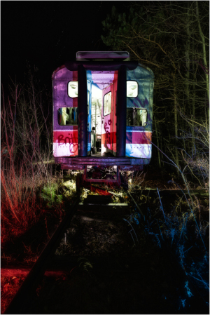 An abandoned trolley, its interior aglow with eldritch hues, looms amidst encroaching shadows.