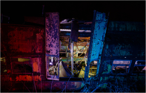 A forsaken trolley, its eldritch form illuminated by ghostly hues, stands in desolation.