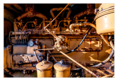 A rusty engine with pipes and gauges, showcasing industrial decay.