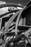 A tangle of ropes and chains, shadows intertwine in a dreamlike embrace.