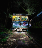 An abandoned trolley, cloaked in graffiti, looms in a shadowy graveyard of forgotten tracks.