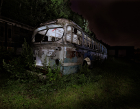 An abandoned, decaying trolley overrun by nature, shrouded in darkness and mystery.
