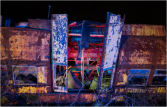 A rusted trolley car stands in eerie silence, its peeling paint revealing shadows of forgotten stories.