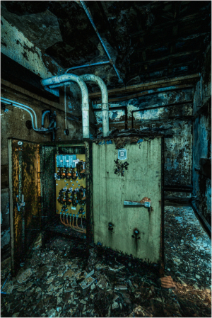 Rusty control box looms in a decaying theater; shadows whisper secrets of the past.