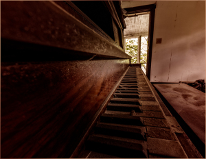 Close-up of an old piano keyboard in a dimly lit room