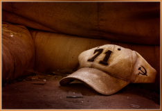 Worn cap with number 71 and symbol resting on a dusty surface